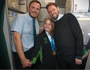 16 March 2025; Gold and Bronze medal winner Maire Connelly of Team Ireland, a member of Kilternan Karvers, Clanbridge, Galway, with Liam O'Shea, left, Senior Cabin Crew, and William McNally, Cabin Crew, on the Aer Lingus flight to Dublin after competing in the Turin 2025 Special Olympics World Winter Games in Italy. Photo by Ray McManus/Sportsfile
