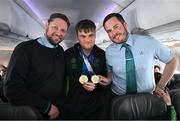 16 March 2025; Double Gold Medal winner Caolan McConville of Team Ireland, a member of Skiability Northern Ireland, Aghaghallon, Antrim with Liam O'Shea, right, Senior Cabin Crew, and William McNally, Cabin Crew, on the Aer Lingus flight to Dublin after competing in the Turin 2025 Special Olympics World Winter Games in Italy. Photo by Ray McManus/Sportsfile