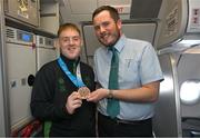 16 March 2025; Bronze Medal winner James Hunter of Team Ireland, a member of Mallow Special Olympics Club, Mallow, Cork  with Liam O'Shea, Senior Cabin Crew, on the Aer Lingus flight to Dublin after competing in the Turin 2025 Special Olympics World Winter Games in Italy. Photo by Ray McManus/Sportsfile