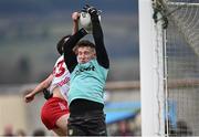 16 March 2025; Donegal goalkeeper Gavin Mulreany wins possession ahead of Darragh Canavan of Tyrone during the Allianz Football League Division 1 match between Donegal and Tyrone at O’Donnell Park in Letterkenny, Donegal. Photo by Piaras Ó Mídheach/Sportsfile