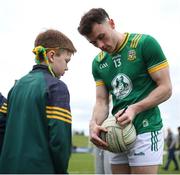 16 March 2025; Jordan Morris of Meath signs the football of supporter Michael O'Reilly, age 8, after the Allianz Football League Division 2 match between Meath and Monaghan at Páirc Tailteann in Navan, Meath. Photo by Thomas Flinkow/Sportsfile