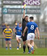 16 March 2025; Referee Sean Hurson shows a yellow card to James Smith of Cavan during the Allianz Football League Division 2 match between Roscommon and Cavan at King & Moffatt Dr Hyde Park in Roscommon. Photo by Tom Beary/Sportsfile