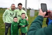 17 March 2025; Mason Geraghty, who was a special guest at a Republic of Ireland training session accompanied by his father Stephen and brother Scott, left, pose for a photograph with Robbie Brady at the FAI National Training Centre in Abbotstown, Dublin. Photo by Stephen McCarthy/Sportsfile