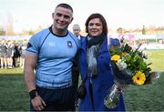 19 March 2025; St Michael's College captain Herbie Boyle presents Anne Lynch, mother of St Vincent's Castleknock College captain Matthew Lynch, with flowers after the Bank of Ireland Leinster Rugby Boys Schools Junior Cup final match between St Michael’s College and St Vincent's Castleknock College at Energia Park in Dublin. Photo by Shauna Clinton/Sportsfile