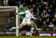 21 March 2025; Isaac Schmidt of Switzerland in action against Ciaron Brown of Northern Ireland during the international friendly match between Northern Ireland and Switzerland at the National Football Stadium at Windsor Park in Belfast. Photo by Ben McShane/Sportsfile
