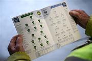 22 March 2025; A steward studies the team line-ups in the match programme before the Allianz Hurling League Division 1B match between Waterford and Offaly at Walsh Park in Waterford. Photo by Seb Daly/Sportsfile