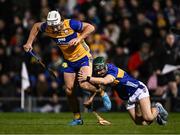22 March 2025; Jack Kirwan of Clare is tackled by Robert Doyle of Tipperary during the Allianz Hurling League Division 1A match between Tipperary and Clare at FBD Semple Stadium in Thurles, Tipperary. Photo by Ben McShane/Sportsfile