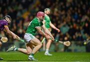 22 March 2025; Shane O'Brien of Limerick scores his side's first goal despite the efforts of Charlie McGuckin of Wexford during the Allianz Hurling League Division 1A match between Limerick and Wexford at TUS Gaelic Grounds in Limerick. Photo by Tom Beary/Sportsfile