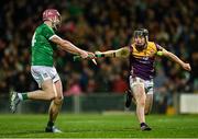22 March 2025; Shane O'Brien of Limerick has a shot at goal despite the attention of Conor Foley of Wexford during the Allianz Hurling League Division 1A match between Limerick and Wexford at TUS Gaelic Grounds in Limerick. Photo by Tom Beary/Sportsfile
