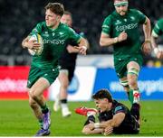 22 March 2025; Matthew Devine of Connacht evades the tackle of Jack Walsh of Ospreys during the United Rugby Championship match between Ospreys and Connacht at Swansea.com Stadium in Swansea, Wales. Photo by Geraint Nicholas/Sportsfile