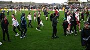 23 March 2025; Children run on the pitch after the hooter went thinking the game was over during the Allianz Football League Division 1 match between Tyrone and Dublin at O'Neills Healy Park in Omagh, Tyrone. Photo by Ray McManus/Sportsfile