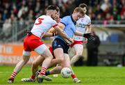 23 March 2025; Peadar Ó Cofaigh Byrne of Dublin is tackled by Peter Teague, 3, and Brian Kennedy of Tyrone during the Allianz Football League Division 1 match between Tyrone and Dublin at O'Neills Healy Park in Omagh, Tyrone. Photo by Ray McManus/Sportsfile