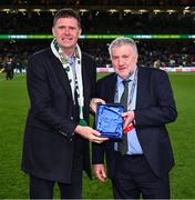 23 March 2025; Former Republic of Ireland international Niall Quinn, right, is presented with a Hall of Fame award by FAI President Paul Cooke during the UEFA Nations League B/C Play-off 2nd Leg match between Republic of Ireland and Bulgaria at the Aviva Stadium in Dublin. Photo by Stephen McCarthy/Sportsfile