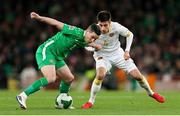 23 March 2025; Josh Cullen of Republic of Ireland in action against Bozhidar Kraev of Bulgaria during the UEFA Nations League B/C Play-off 2nd Leg match between Republic of Ireland and Bulgaria at the Aviva Stadium in Dublin. Photo by Thomas Flinkow/Sportsfile