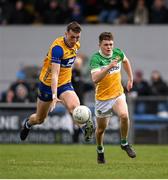 23 March 2025; Emmet McMahon of Clare in action against John Furlong of Offaly during the Allianz Football League Division 3 match between Clare and Offaly at Cusack Park in Ennis, Clare. Photo by Tom Beary/Sportsfile