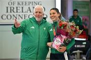 25 March 2025; Ireland athlete and pentathlon silver medallist Kate O'Connor with Athletics Ireland President John Cronin upon her arrival at Dublin Airport from the World Indoor Athletics Championships at the Nanjing Youth Olympic Sports Park in Nanjing, China. Photo by Sam Barnes/Sportsfile