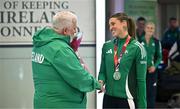 25 March 2025; Ireland athlete and pentathlon silver medallist Kate O'Connor with Athletics Ireland President John Cronin upon her arrival at Dublin Airport from the World Indoor Athletics Championships at the Nanjing Youth Olympic Sports Park in Nanjing, China. Photo by Sam Barnes/Sportsfile