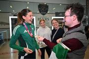 25 March 2025; Ireland athlete and pentathlon silver medallist Kate O'Connor with her cousin George Allen upon her arrival at Dublin Airport from the World Indoor Athletics Championships at the Nanjing Youth Olympic Sports Park in Nanjing, China. Photo by Sam Barnes/Sportsfile