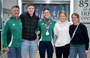 25 March 2025; Ireland athlete and pentathlon silver medallist Kate O'Connor, centre, with her family, from left, father and coach Michael O'Connor, brother Ruairi O'Connor, sister Meabh O'Connor and mother Valerie O'Connor upon her arrival at Dublin Airport from the World Indoor Athletics Championships at the Nanjing Youth Olympic Sports Park in Nanjing, China. Photo by Sam Barnes/Sportsfile