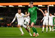23 March 2025; Evan Ferguson of Republic of Ireland and Fabian Nuernberger of Bulgaria during the UEFA Nations League B/C Play-off 2nd Leg match between Republic of Ireland and Bulgaria at the Aviva Stadium in Dublin. Photo by Ben McShane/Sportsfile
