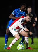 28 March 2025; Chris Forrester of St Patrick's Athletic in action against James Olayinka of Waterford during the SSE Airtricity Men's Premier Division match between Waterford and St Patrick's Athletic at the Regional Sports Centre in Waterford. Photo by Michael P Ryan/Sportsfile