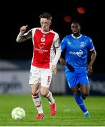 28 March 2025; Chris Forrester of St Patrick's Athletic in action against James Olayinka of Waterford during the SSE Airtricity Men's Premier Division match between Waterford and St Patrick's Athletic at the Regional Sports Centre in Waterford. Photo by Michael P Ryan/Sportsfile