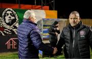 28 March 2025; Galway United manager John Caulfield, left, and Bohemians manager Alan Reynolds shake hands after the SSE Airtricity Men's Premier Division match between Bohemians and Galway United at Dalymount Park in Dublin. Photo by Thomas Flinkow/Sportsfile