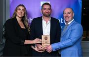 31 March 2025; Ronan Gavin, centre, father of DCU Dóchas Éireann player Alex Gavin, not pictured, accepts the 2025 Electric Ireland Higher Education GAA Football Rising Stars Team of the Year award on behalf of his son, from Electric Ireland Sponsorship Manager Sarah Gelletlie, left, and Higher Education GAA Chairperson Benny Hurl during the Electric Ireland Higher Education Rising Stars Awards at Castleknock Hotel in Dublin. Photo by Shauna Clinton/Sportsfile