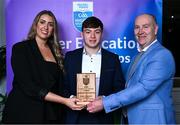 31 March 2025; DCU Dóchas  Éireann player Bryan Masterson, centre, is presented with his 2025 Electric Ireland Higher Education GAA Football Rising Stars Team of the Year award by Electric Ireland Sponsorship Manager Sarah Gelletlie, left, and Higher Education GAA Chairperson Benny Hurl during the Electric Ireland Higher Education Rising Stars Awards at Castleknock Hotel in Dublin. Photo by Shauna Clinton/Sportsfile