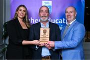 31 March 2025; Shane McEnaney, centre, father of DCU Dóchas Éireann player Greg McEnaney, not pictured, accepts the 2025 Electric Ireland Higher Education GAA Football Rising Stars Team of the Year award on behalf of his son, from Electric Ireland Sponsorship Manager Sarah Gelletlie, left, and Higher Education GAA Chairperson Benny Hurl during the Electric Ireland Higher Education Rising Stars Awards at Castleknock Hotel in Dublin. Photo by Shauna Clinton/Sportsfile
