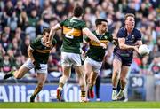 30 March 2025; Eoghan McLaughlin of Mayo makes a pass despite the attention of Kerry players, from left, Barry Dan O'Sullivan, Paul Murphy and Brian Ó Beaglaoich during the Allianz Football League Division 1 final match between Kerry and Mayo at Croke Park in Dublin. Photo by Shauna Clinton/Sportsfile