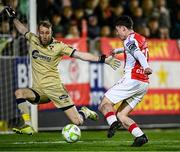 4 April 2025; Kian Leavy of St Patrick's Athletic in action against Shelbourne goalkeeper Conor Kearns during the SSE Airtricity Men's Premier Division match between St Patrick's Athletic and Shelbourne at Richmond Park in Dublin. Photo by Seb Daly/Sportsfile