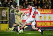 4 April 2025; Kian Leavy of St Patrick's Athletic in action against Shelbourne goalkeeper Conor Kearns during the SSE Airtricity Men's Premier Division match between St Patrick's Athletic and Shelbourne at Richmond Park in Dublin. Photo by Seb Daly/Sportsfile
