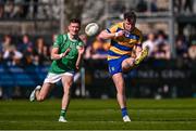 5 April 2025; Cian Mckeon of Roscommon kicks a point despite the attention of Kristian Healy of London during the Connacht GAA Football Senior Championship quarter-final match between London and Roscommon at McGovern Park in Ruislip, England. Photo by Ben McShane/Sportsfile