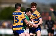 5 April 2025; Nathan McElwaine of London is tackled by Ciaráin Murtagh, left, and Colm Neary of Roscommon during the Connacht GAA Football Senior Championship quarter-final match between London and Roscommon at McGovern Park in Ruislip, England. Photo by Ben McShane/Sportsfile