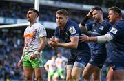 5 April 2025; Garry Ringrose of Leinster celebrates with teammates Hugo Keenan and Tadhg Furlong after scoring their side's fifth try during the Investec Champions Cup Round of 16 match between Leinster and Harlequins at Croke Park in Dublin. Photo by Brendan Moran/Sportsfile