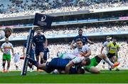 5 April 2025; Ross Byrne of Leinster scores his side's eighth try despite the efforts of Jamie Benson of Harlequins during the Investec Champions Cup Round of 16 match between Leinster and Harlequins at Croke Park in Dublin. Photo by Sam Barnes/Sportsfile