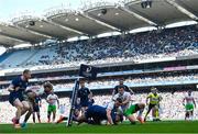 5 April 2025; Ross Byrne of Leinster scores his side's eighth try despite the efforts of Jamie Benson of Harlequins during the Investec Champions Cup Round of 16 match between Leinster and Harlequins at Croke Park in Dublin. Photo by Sam Barnes/Sportsfile