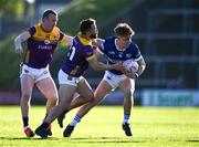 5 April 2025; Simon Fingleton of Laois in action against Conor Carty and Graeme Cullen of Wexford during the Leinster GAA Football Senior Championship round one match between Wexford and Laois at Chadwicks Wexford Park in Wexford. Photo by Ray McManus/Sportsfile