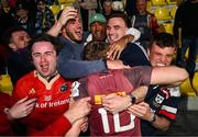 5 April 2025; Jack Crowley of Munster celebrates with Munster players Alex Nankivell and Shane Daly, and former Munster player Simon Zebo after the Investec Champions Cup Round of 16 match between La Rochelle and Munster at Stade Marcel Deflandre in La Rochelle, France. Photo by Ramsey Cardy/Sportsfile