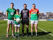 6 April 2025; Referee Paul Faloon with Meath captain Eoghan Frayne, Carlow captain Mikey Bambrick, and mascot Jake Robinson before the Leinster GAA Football Senior Championship round one match between Meath and Carlow at Pairc Tailteann in Navan, Meath. Photo by Thomas Flinkow/Sportsfile