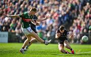 6 April 2025; Jack Carney of Mayo has a shot on goal despite the efforts of Eddie McGuinness of Sligo during the Connacht GAA Football Senior Championship quarter-final match between Mayo and Sligo at Hastings Insurance MacHale Park in Castlebar, Mayo. Photo by Sam Barnes/Sportsfile