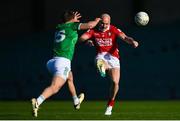 5 April 2025; Brian O'Driscoll of Cork kicks a two point score from outside the 40m arc despite the efforts of Cillian Fahy of Limerick during the Munster GAA Football Senior Championship quarter-final match between Limerick and Cork at TUS Gaelic Grounds in Limerick. Photo by Tom Beary/Sportsfile