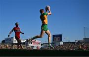 6 April 2025; Ciaran Moore of Donegal in action against Conor Glass of Derry during the Ulster GAA Football Senior Championship preliminary round match between Donegal and Derry at MacCumhaill Park in Ballybofey, Donegal. Photo by David Fitzgerald/Sportsfile