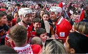 6 April 2025; Cork players Patrick Horgan, left, and Tim O'Mahony on the pitch with supporters after their side's victory in the Allianz Hurling League Division 1A final match between Tipperary and Cork at SuperValu Páirc Uí Chaoimh in Cork. Photo by Piaras Ó Mídheach/Sportsfile