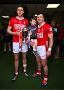 6 April 2025; Cork captain Robert Downey, left, and teammate Patrick Horgan, with his son Jack, and the cup after the Allianz Hurling League Division 1A final match between Tipperary and Cork at SuperValu Páirc Uí Chaoimh in Cork. Photo by Brendan Moran/Sportsfile