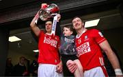 6 April 2025; Cork captain Robert Downey, left, and teammate Patrick Horgan, with his son Jack, and the cup after the Allianz Hurling League Division 1A final match between Tipperary and Cork at SuperValu Páirc Uí Chaoimh in Cork. Photo by Brendan Moran/Sportsfile