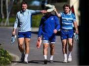 7 April 2025; Lee Barron, left, and John McKee, right, provide cover to team-mate Scott Penny as they arrive for Leinster Rugby squad training at UCD in Dublin. Photo by Piaras Ó Mídheach/Sportsfile