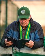 4 April 2025; A Kerry supporter reads the match programe before the SSE Airtricity Men's First Division match between Treaty United and Kerry FC at Markets Field in Limerick. Photo by Michael P Ryan/Sportsfile
