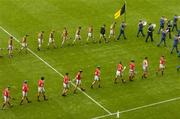 12 September 2004; The Cork and Kilkenny players during the pre-match parade. Guinness All-Ireland Senior Hurling Championship Final, Cork v Kilkenny, Croke Park, Dublin. Picture credit; Pat Murphy / SPORTSFILE *** Local Caption *** Any photograph taken by SPORTSFILE during, or in connection with, the 2004 Guinness All-Ireland Hurling Final which displays GAA logos or contains an image or part of an image of any GAA intellectual property, or, which contains images of a GAA player/players in their playing uniforms, may only be used for editorial and non-advertising purposes.  Use of photographs for advertising, as posters or for purchase separately is strictly prohibited unless prior written approval has been obtained from the Gaelic Athletic Association.